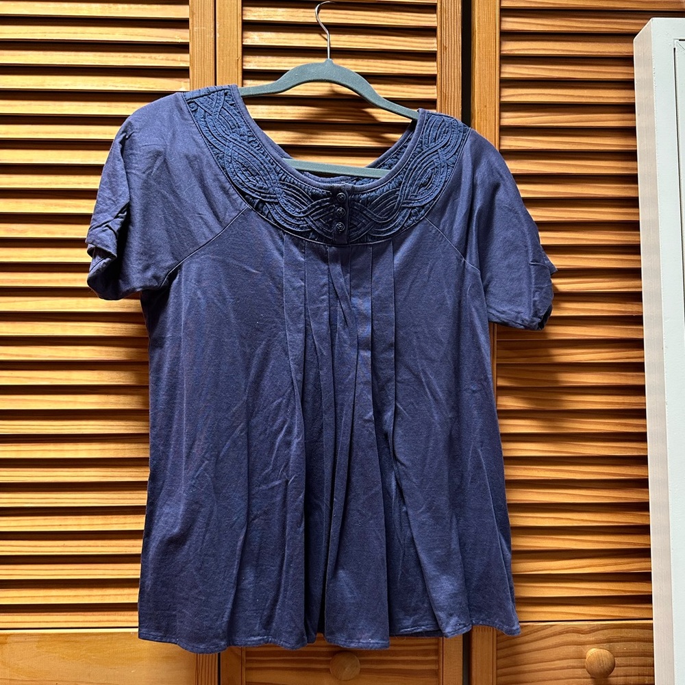 Deletta purple top with design around collar. Button up.
